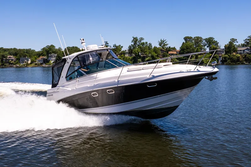 Four Fans Yacht Photos Pics 2008 Four Winns V378 boat cruising on a lake under clear blue skies.