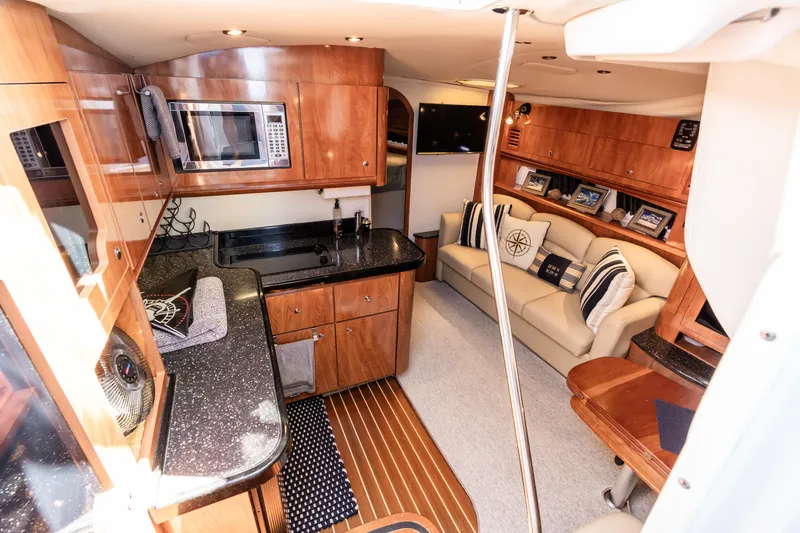 Four Fans Yacht Photos Pics Luxurious 2008 Four Winns V378 yacht interior with kitchen and cozy seating area.
