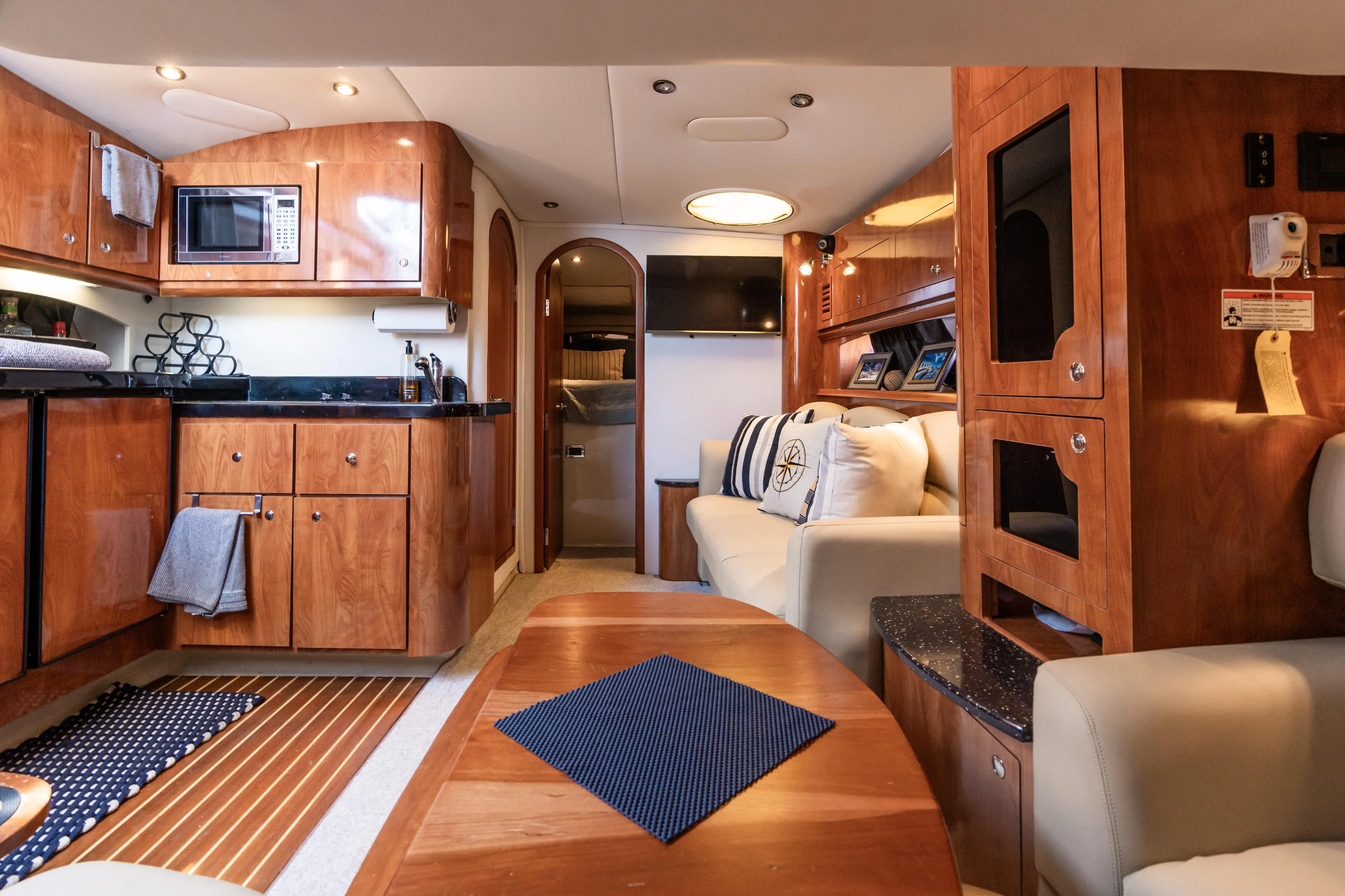 Four Fans Yacht Photos Pics Luxurious interior of 2008 Four Winns V378 yacht with modern kitchen and cozy seating area.