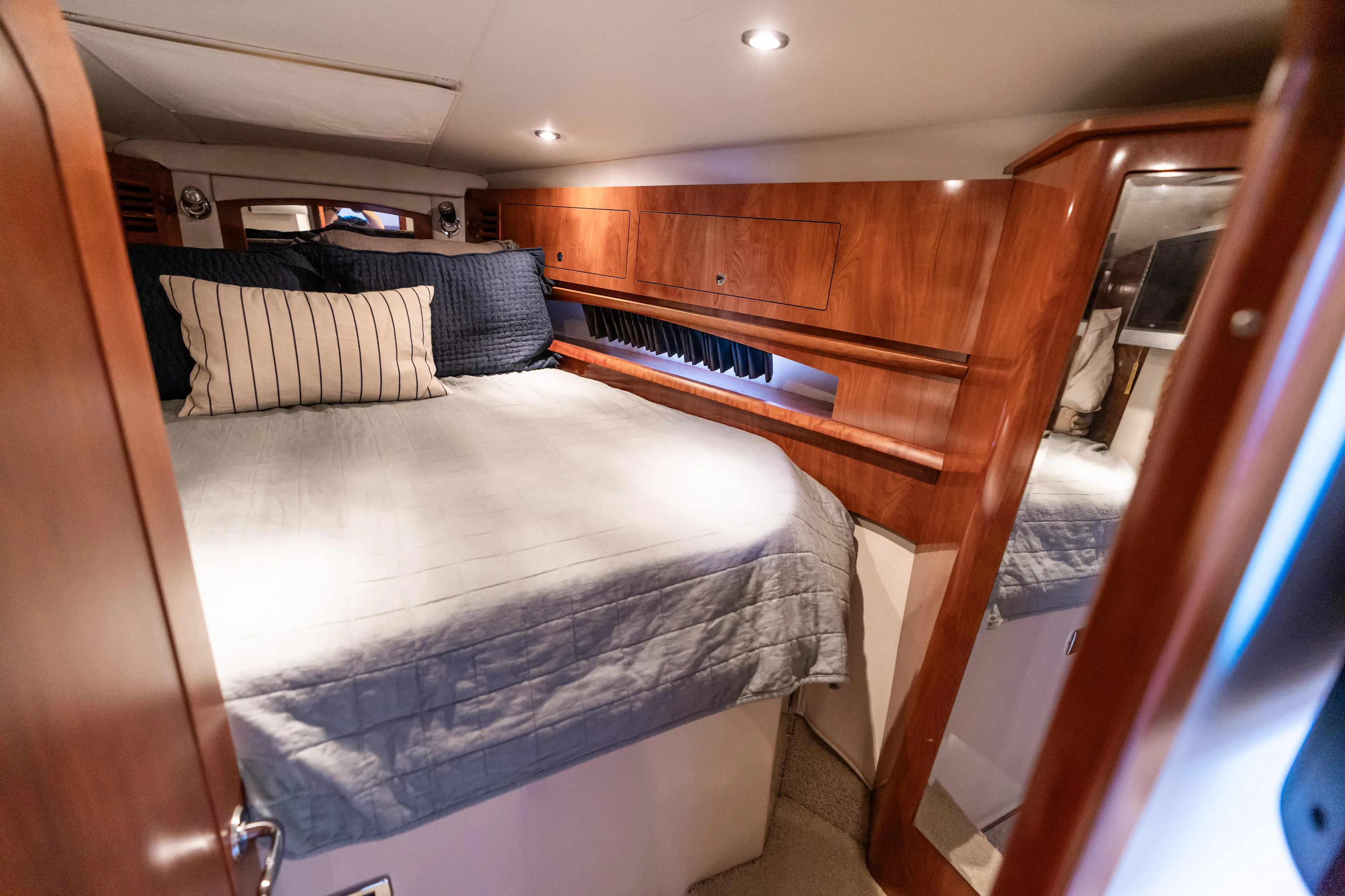 Four Fans Yacht Photos Pics Luxurious cabin interior of 2008 Four Winns V378 yacht with cozy bedding and wooden accents.