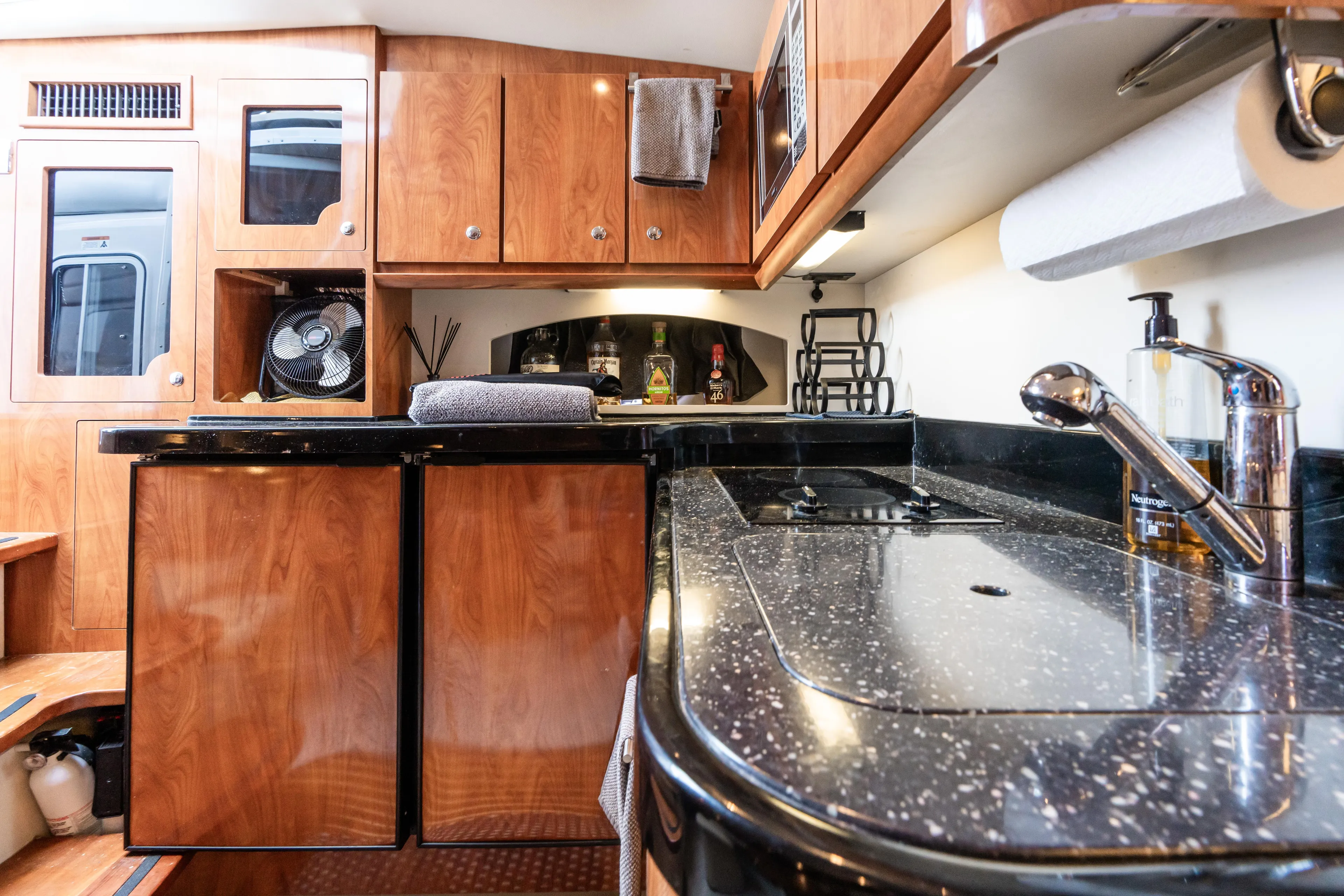 Four Fans Yacht Photos Pics Luxurious 2008 Four Winns V378 yacht interior with sleek kitchen and wooden cabinetry.