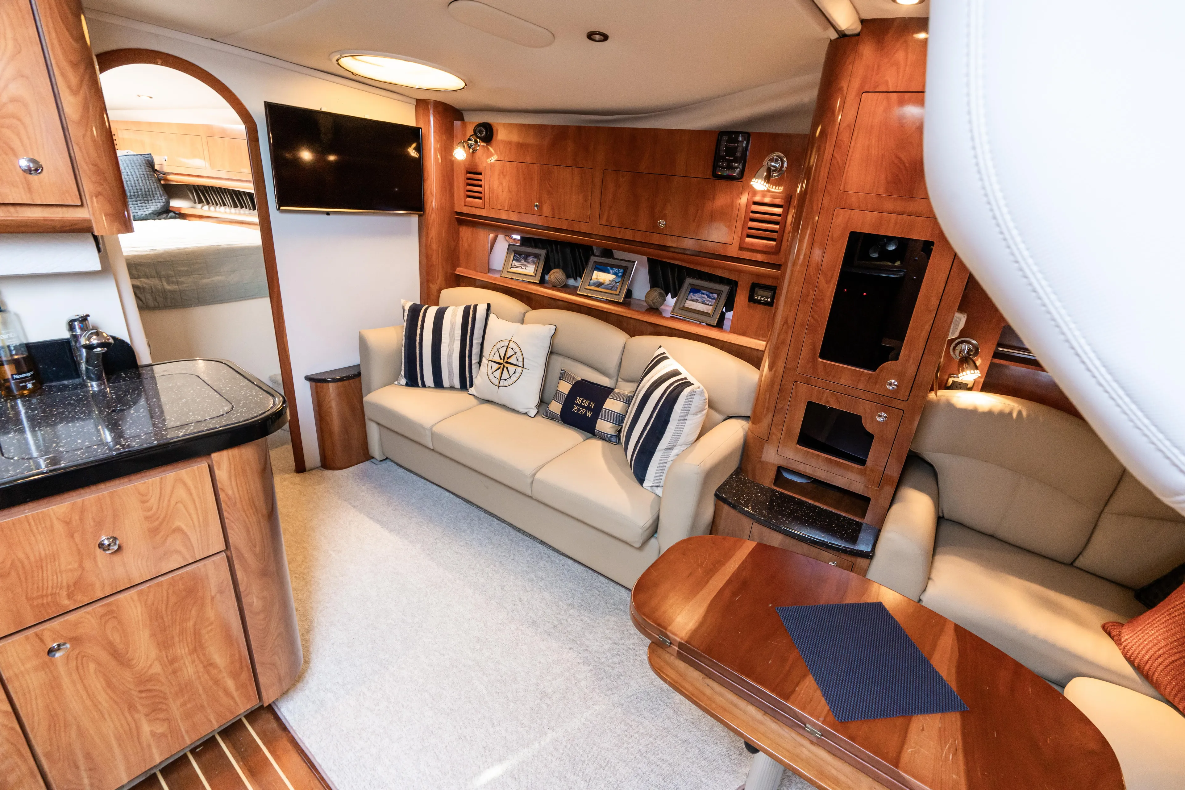 Four Fans Yacht Photos Pics Luxurious interior of 2008 Four Winns V378 yacht with elegant wood finishes and comfortable seating.