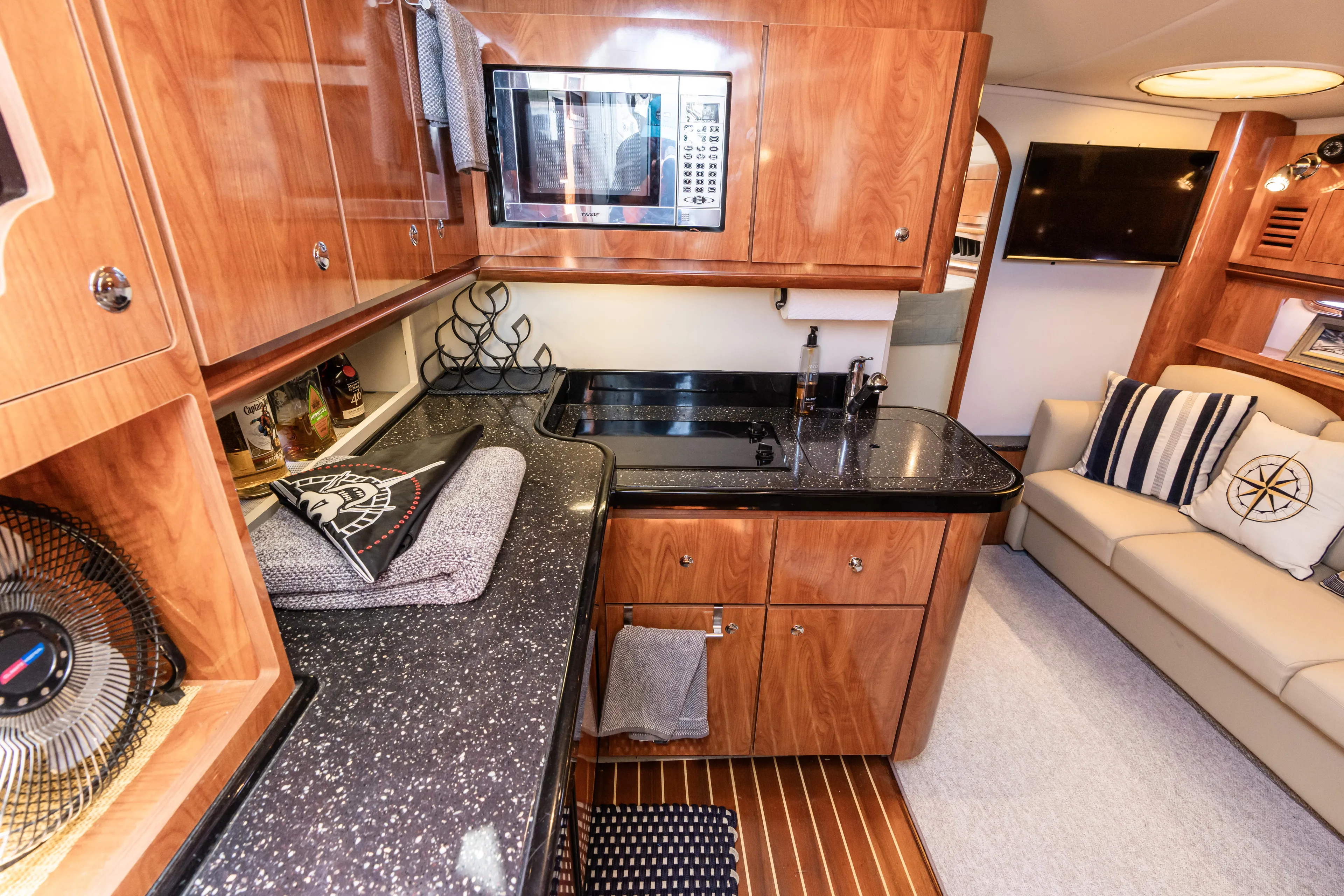 Four Fans Yacht Photos Pics Luxurious 2008 Four Winns V378 yacht interior with modern kitchen and cozy seating area.