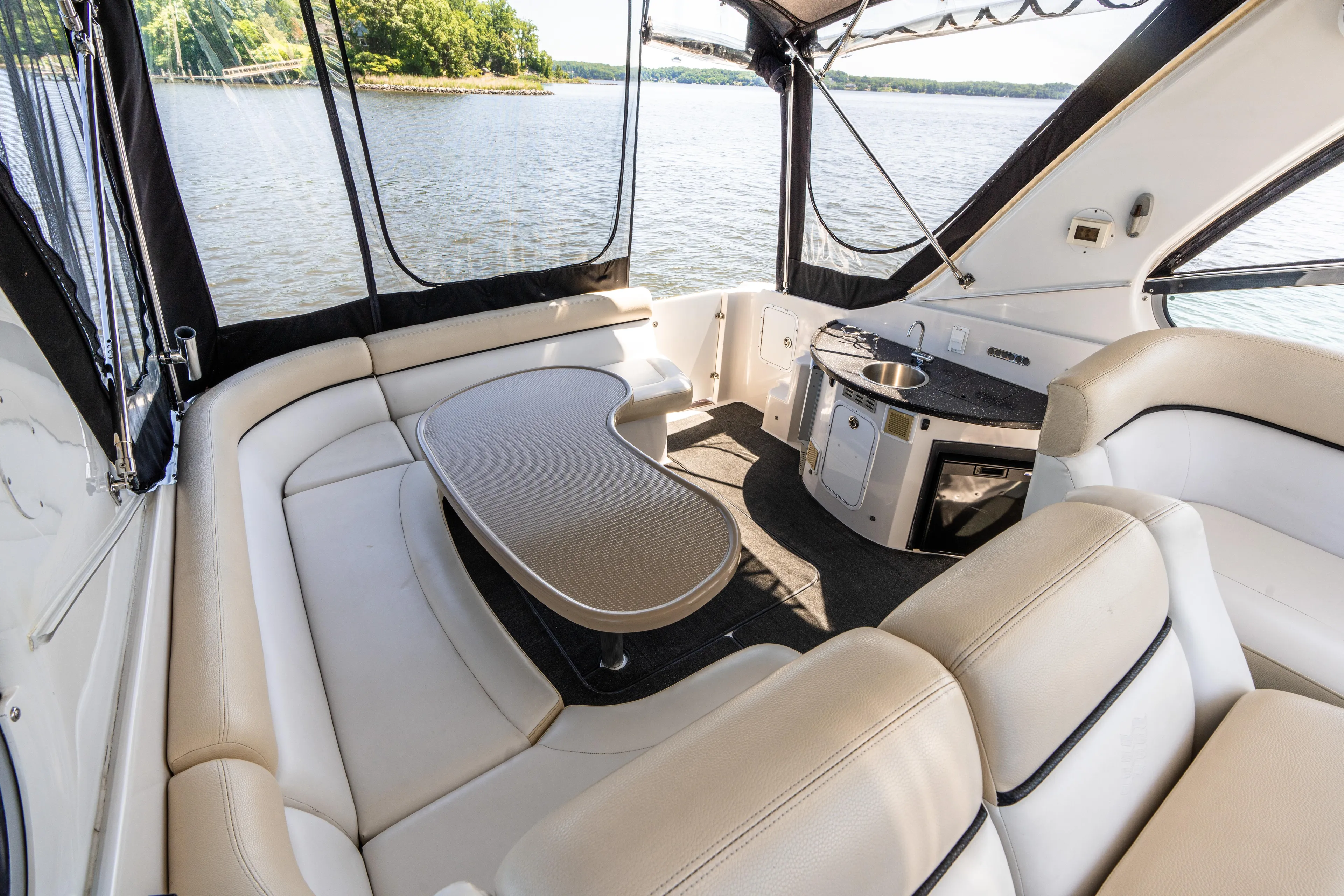 Four Fans Yacht Photos Pics Luxurious interior of 2008 Four Winns V378 yacht with seating and kitchenette.