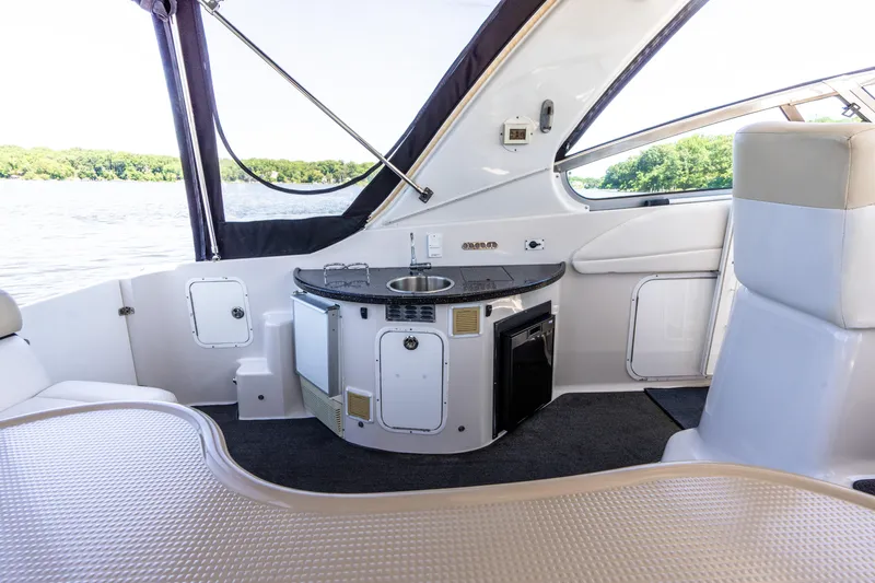 Four Fans Yacht Photos Pics Interior of 2008 Four Winns V378 yacht with kitchenette and seating area.