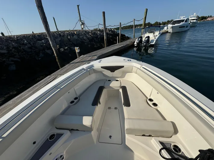  Yacht Photos Pics 2023 Sailfish 312 CC boat docked, showcasing spacious seating and sleek design.