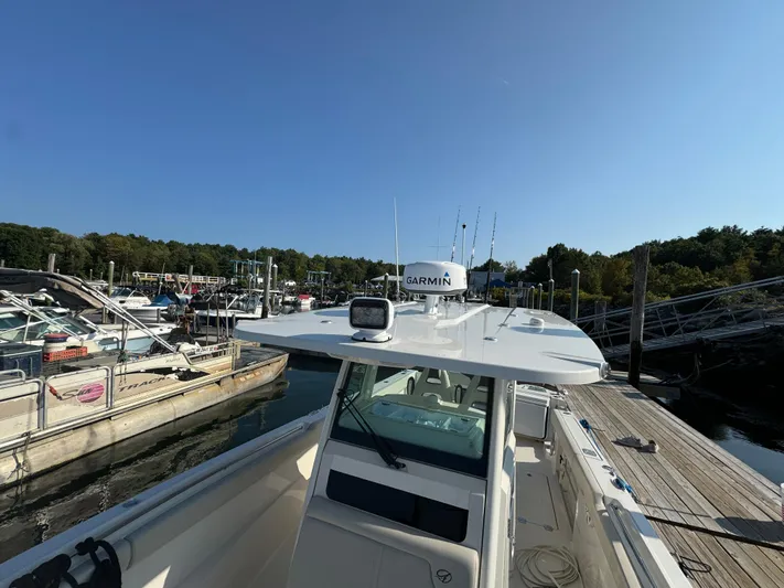  Yacht Photos Pics 2023 Sailfish 312 CC boat docked at marina under clear blue sky.