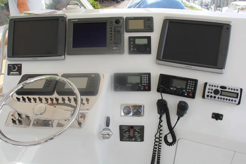 Yacht Photos Pics Control panel of 2005 Cabo Flybridge CAT C18 with navigation and communication equipment.