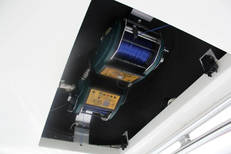  Yacht Photos Pics Fishing reel setup on 2005 Cabo Flybridge CAT C18 boat ceiling.