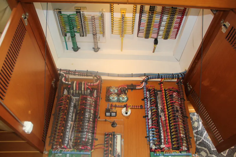  Yacht Photos Pics Electrical panel inside 2005 Cabo Flybridge CAT C18 boat, showcasing organized wiring and components.