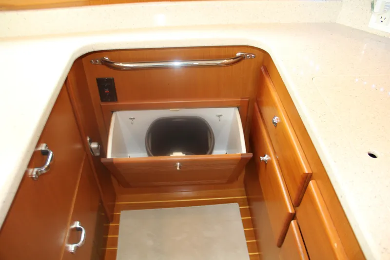  Yacht Photos Pics 2005 Cabo Flybridge CAT C18 yacht interior with wooden cabinetry and built-in storage compartment.