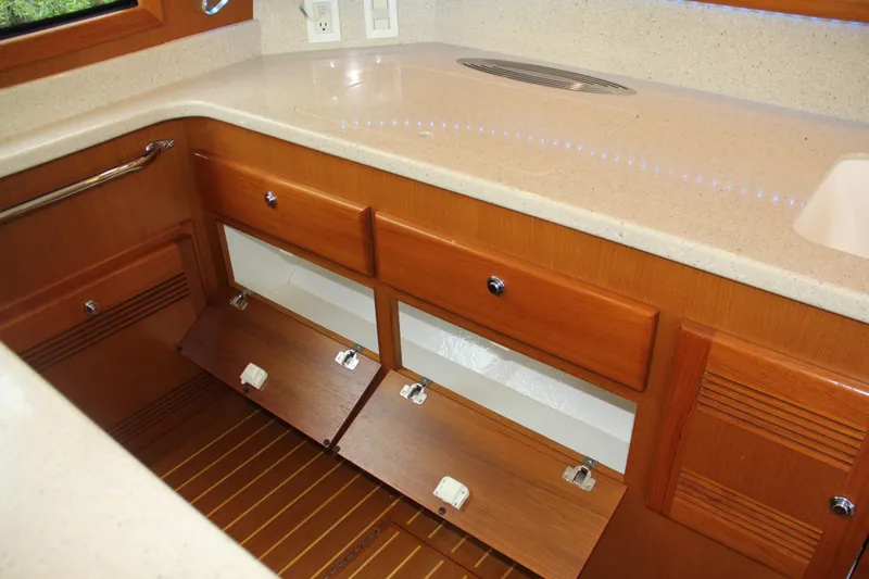  Yacht Photos Pics Luxurious wooden cabinetry in 2005 Cabo Flybridge CAT C18 yacht kitchen.
