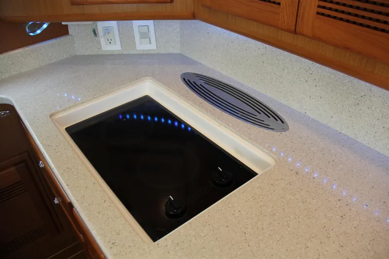  Yacht Photos Pics Modern kitchen countertop with built-in stove on 2005 Cabo Flybridge CAT C18 yacht.