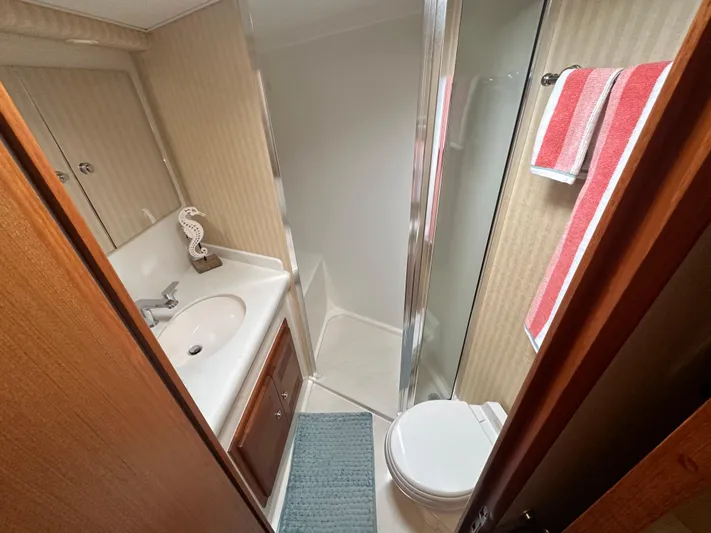  Yacht Photos Pics 2005 Cabo Flybridge CAT C18 bathroom with shower, sink, and toilet.