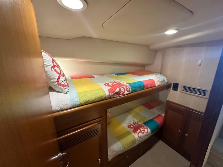  Yacht Photos Pics Bunk beds in 2005 Cabo Flybridge CAT C18 yacht cabin with colorful bedding.