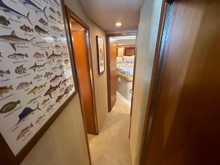  Yacht Photos Pics Hallway inside 2005 Cabo Flybridge CAT C18 yacht, featuring fish chart and cozy interior.