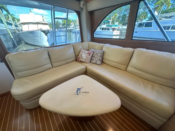  Yacht Photos Pics Luxurious interior of 2005 Cabo Flybridge CAT C18 yacht with cream leather seating.