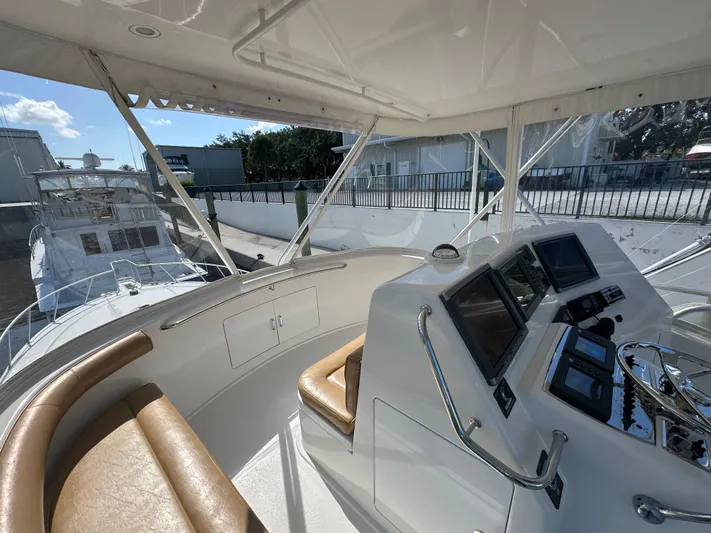  Yacht Photos Pics Flybridge of 2005 Cabo Flybridge CAT C18 yacht with helm and seating area.