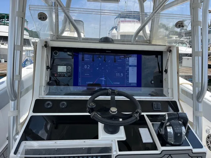 Albie Fishing Yacht Photos Pics 2007 SeaVee 34B boat dashboard with navigation display and controls.