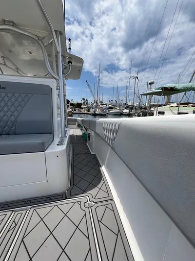 Albie Fishing Yacht Photos Pics 2007 SeaVee 34B boat interior with quilted seating, docked at a marina under cloudy skies.