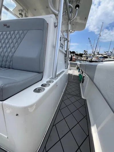 Albie Fishing Yacht Photos Pics 2007 SeaVee 34B boat interior with gray seating and rod holders, docked at marina.
