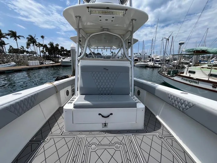 Albie Fishing Yacht Photos Pics 2007 SeaVee 34B boat interior with cushioned seating, docked in a marina under a cloudy sky.