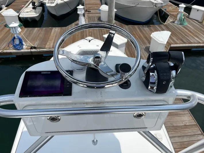 Albie Fishing Yacht Photos Pics 2007 SeaVee 34B boat helm with steering wheel, controls, and Simrad display at dock.