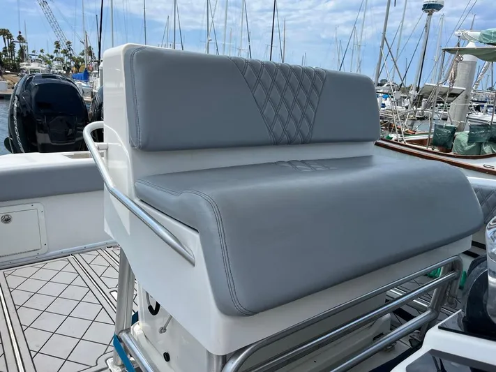 Albie Fishing Yacht Photos Pics 2007 SeaVee 34B boat with gray cushioned seating, docked at a marina.