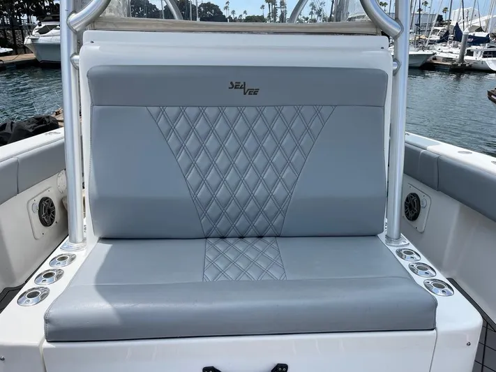 Albie Fishing Yacht Photos Pics 2007 SeaVee 34B boat seat with diamond-patterned upholstery, docked at a marina.