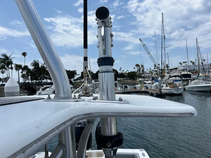 Albie Fishing Yacht Photos Pics 2007 SeaVee 34B boat detail with marina background, featuring metal fixtures and clear sky.