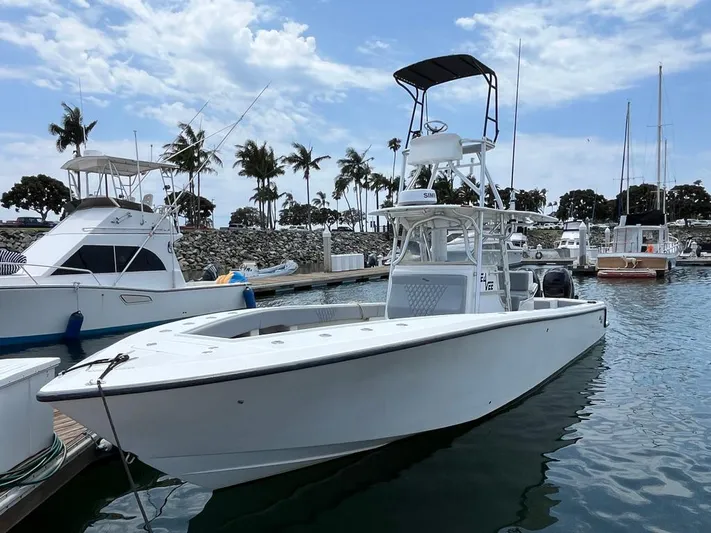 Albie Fishing Yacht Photos Pics 2007 SeaVee 34B boat docked in a marina with palm trees and clear sky.