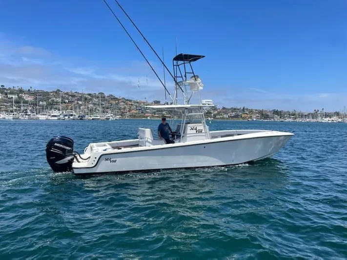 Albie Fishing Yacht Photos Pics 2007 SeaVee 34B boat cruising on a sunny day near a marina.