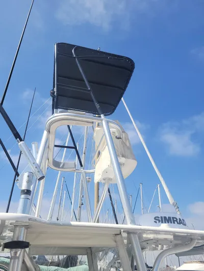 Albie Fishing Yacht Photos Pics 2007 SeaVee 34B boat with tower and Simrad equipment against a clear blue sky.