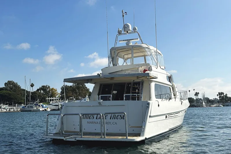 Times Like These Yacht Photos Pics 2004 McKinna 57 PHMY Widebody yacht docked in a marina under a clear blue sky.
