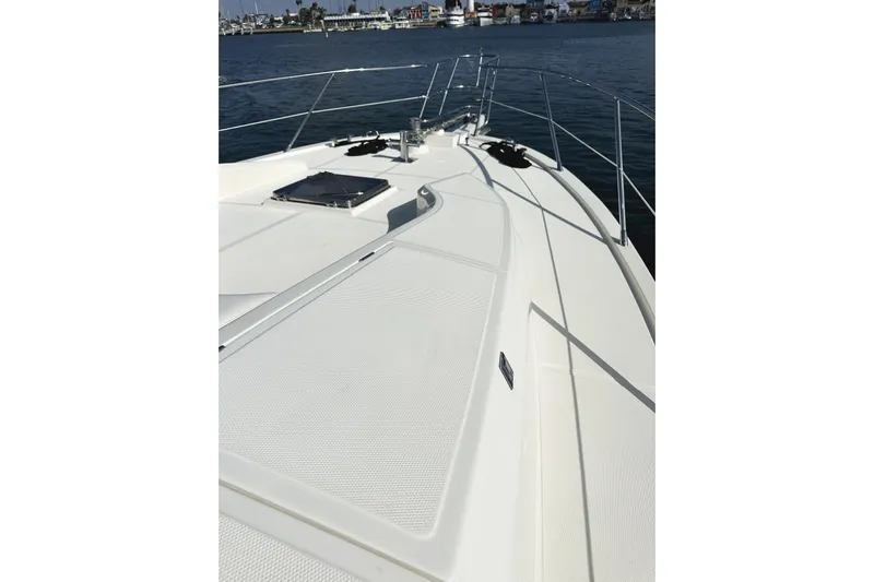 Times Like These Yacht Photos Pics 2004 McKinna 57 PHMY Widebody yacht deck with stabilization, docked in a marina.