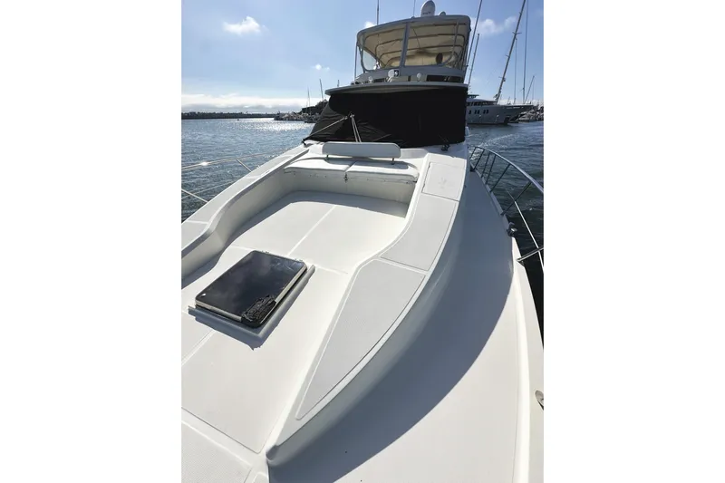 Times Like These Yacht Photos Pics 2004 McKinna 57 PHMY Widebody yacht with stabilization, docked in a sunny marina.