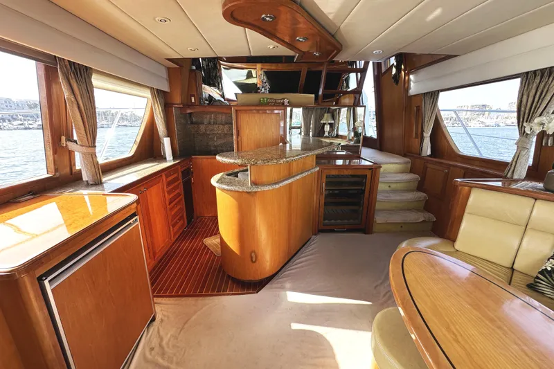 Times Like These Yacht Photos Pics Luxurious interior of a 2004 McKinna 57 PHMY yacht with elegant wood finishes.
