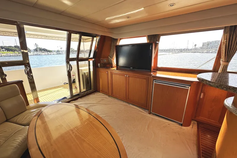 Times Like These Yacht Photos Pics Luxurious 2004 McKinna 57 yacht interior with TV, seating, and ocean view.
