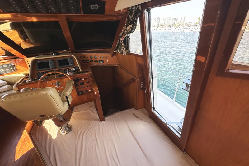 Times Like These Yacht Photos Pics 2004 McKinna 57 PHMY yacht helm with wooden interior and ocean view.