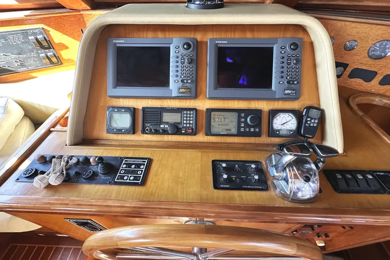 Times Like These Yacht Photos Pics Control panel of a 2004 McKinna 57 PHMY Widebody yacht with navigation equipment.