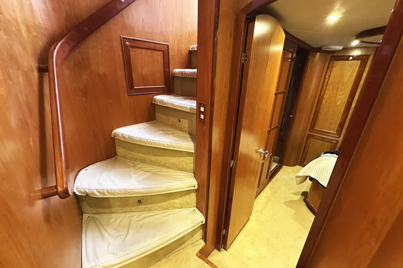Times Like These Yacht Photos Pics Interior of 2004 McKinna 57 PHMY yacht, featuring wooden stairs and hallway.