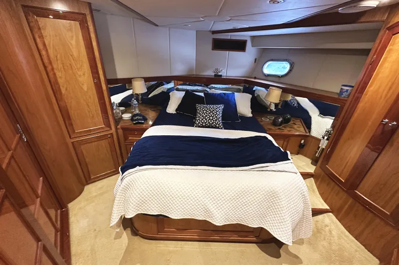 Times Like These Yacht Photos Pics Luxurious cabin interior of 2004 McKinna 57 PHMY yacht with elegant bedding and wood finishes.