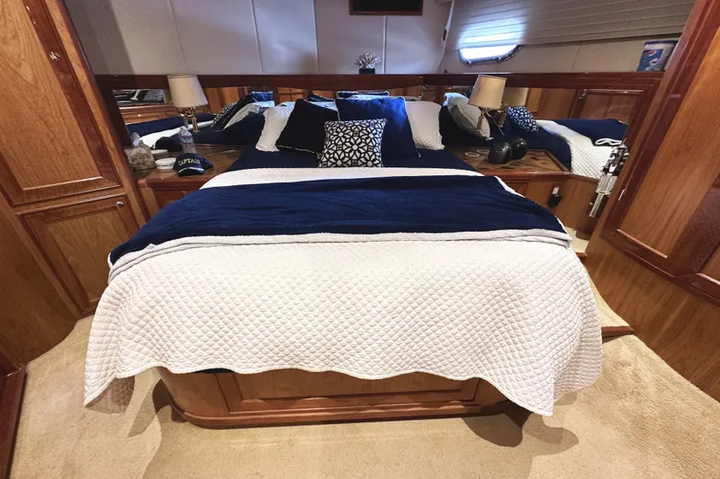 Times Like These Yacht Photos Pics Luxurious bedroom interior of 2004 McKinna 57 PHMY yacht with elegant bedding and wood accents.