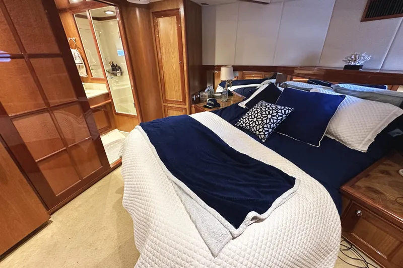 Times Like These Yacht Photos Pics Luxurious bedroom interior of 2004 McKinna 57 PHMY yacht with elegant bedding and wood finishes.