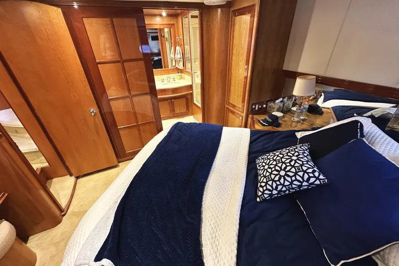 Times Like These Yacht Photos Pics Luxurious bedroom interior of 2004 McKinna 57 PHMY yacht with elegant wood finishes.