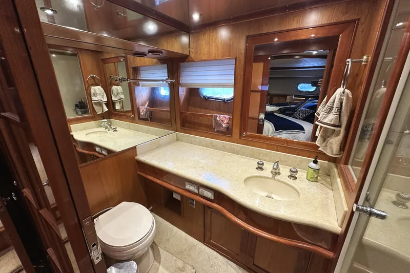 Times Like These Yacht Photos Pics Luxurious bathroom in 2004 McKinna 57 PHMY yacht with wood accents and modern fixtures.