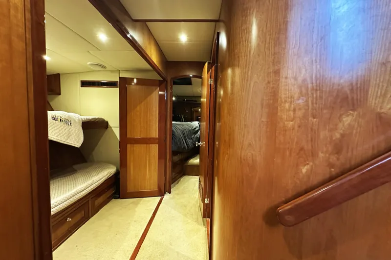 Times Like These Yacht Photos Pics Interior of 2004 McKinna 57 PHMY yacht with wooden finishes and cozy sleeping area.