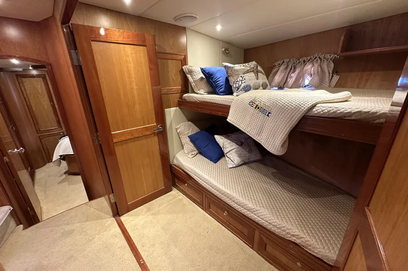 Times Like These Yacht Photos Pics Luxurious 2004 McKinna 57 PHMY yacht cabin with cozy bunk beds and elegant wood finish.