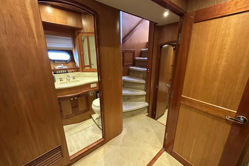Times Like These Yacht Photos Pics Interior of 2004 McKinna 57 PHMY yacht with wooden finishes and staircase.