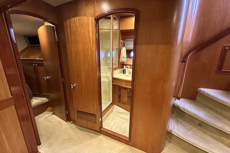 Times Like These Yacht Photos Pics Interior of 2004 McKinna 57 PHMY yacht, featuring wood paneling and a compact bathroom.